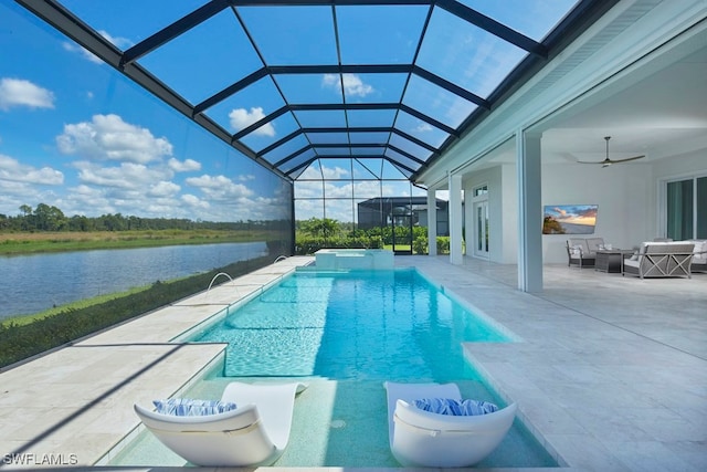 view of swimming pool with outdoor lounge area, a water view, a patio, glass enclosure, and ceiling fan