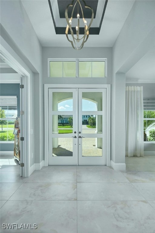 doorway featuring french doors and a chandelier