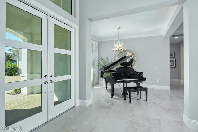 misc room with ornamental molding, french doors, and an inviting chandelier