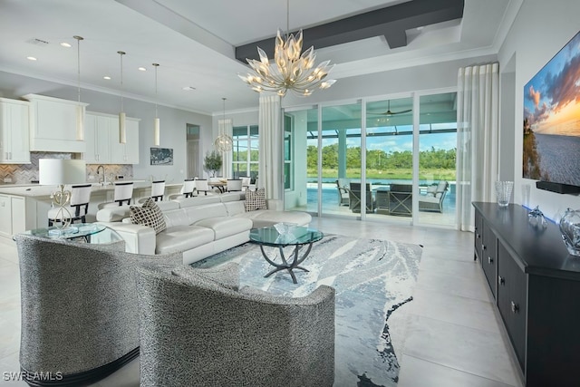 living room with a notable chandelier, sink, light tile patterned floors, and crown molding