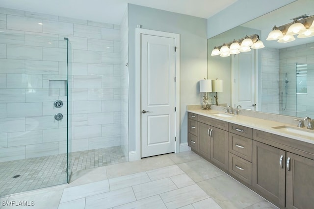 bathroom with vanity, a tile shower, and tile patterned floors