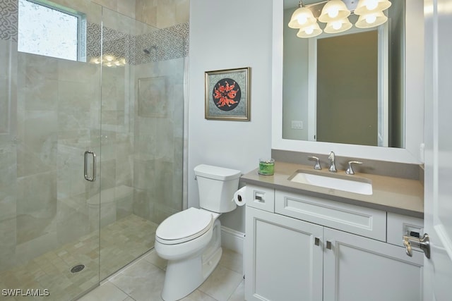 bathroom with toilet, a shower with shower door, vanity, and tile patterned flooring