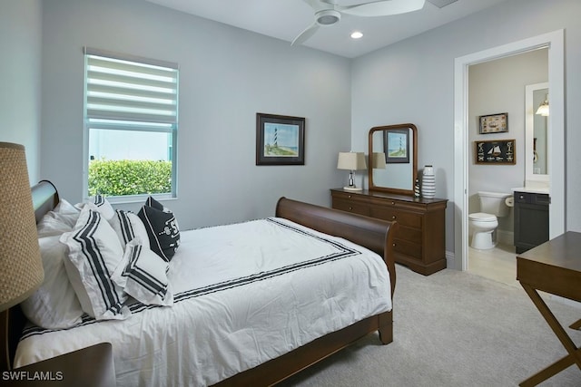 carpeted bedroom with connected bathroom and ceiling fan