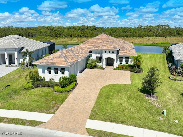 view of front facade with a front lawn and a water view