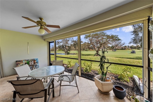 sunroom / solarium with a healthy amount of sunlight and ceiling fan