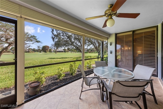 sunroom with a wealth of natural light and ceiling fan