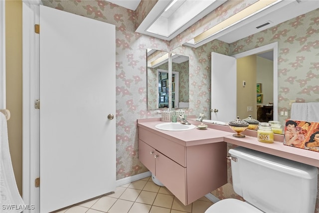 bathroom featuring vanity, toilet, and tile patterned floors