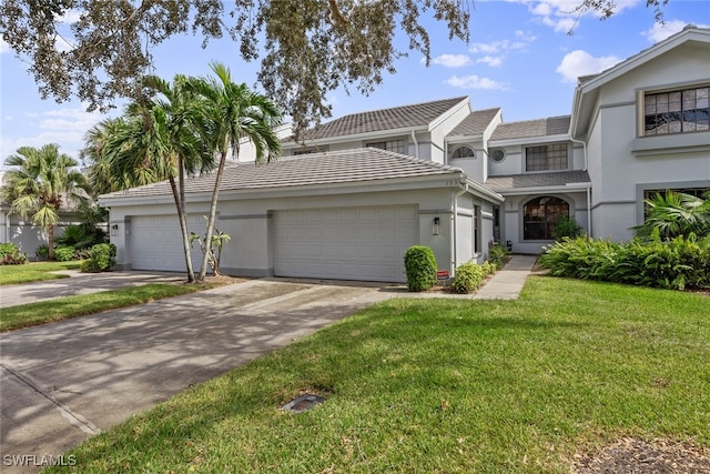 view of front of house featuring a front yard and a garage