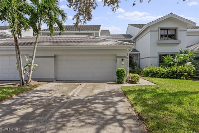 view of front of house featuring a front yard and a garage