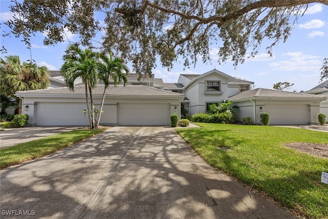 front of property with a front lawn and a garage