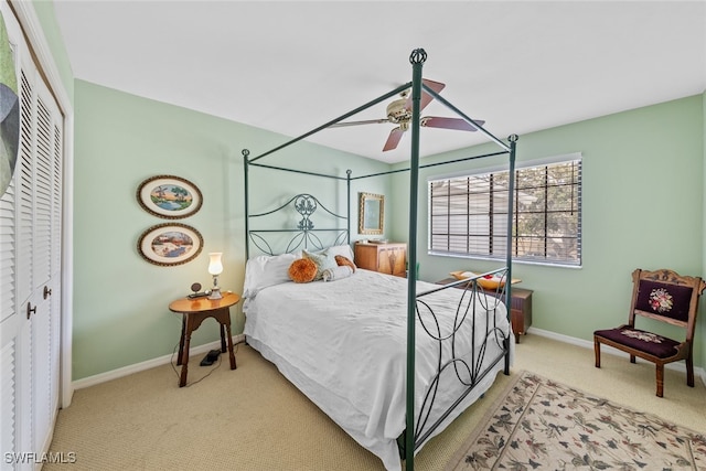 carpeted bedroom featuring a closet and ceiling fan