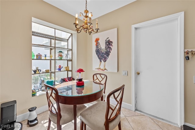 tiled dining room with a notable chandelier