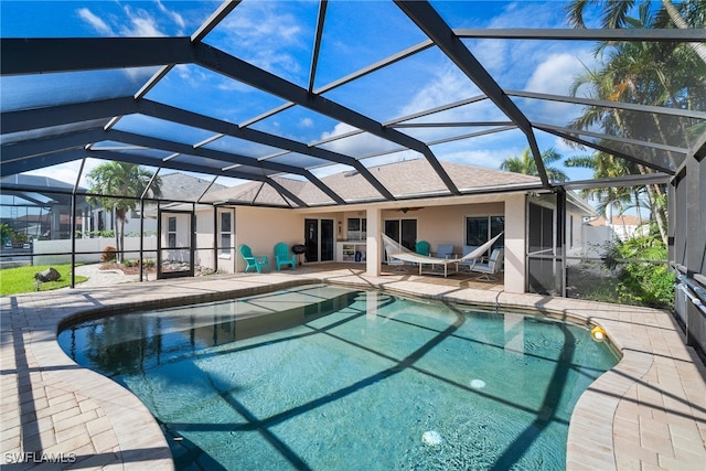 view of pool featuring a patio and glass enclosure