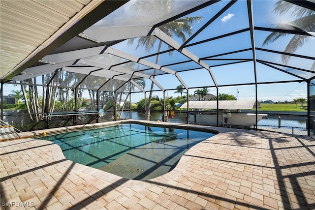 view of swimming pool with a water view, a patio, and a lanai