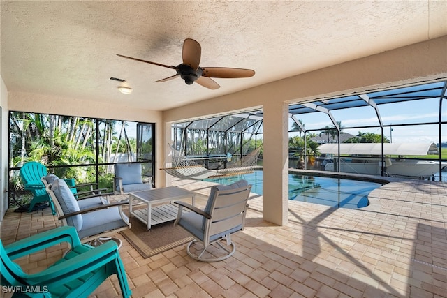 view of pool with a patio, an outdoor hangout area, a lanai, and ceiling fan