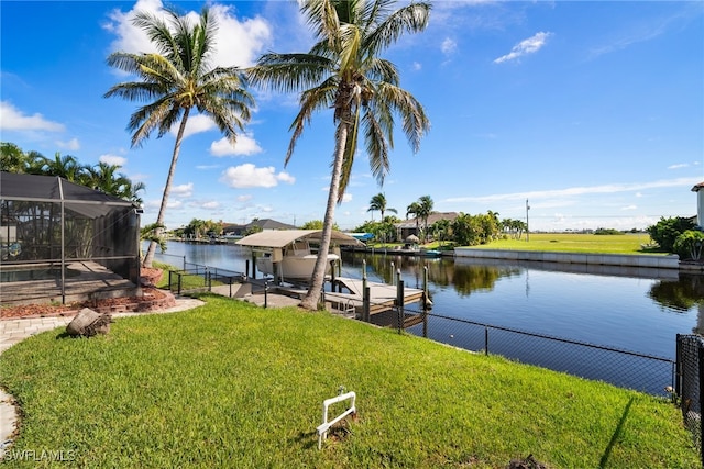 view of dock with a lawn, a water view, and glass enclosure