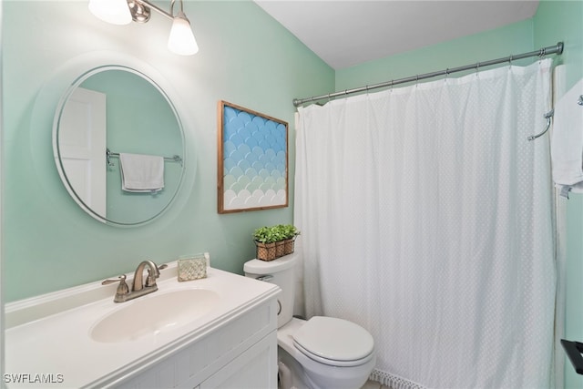 bathroom featuring vanity, curtained shower, and toilet