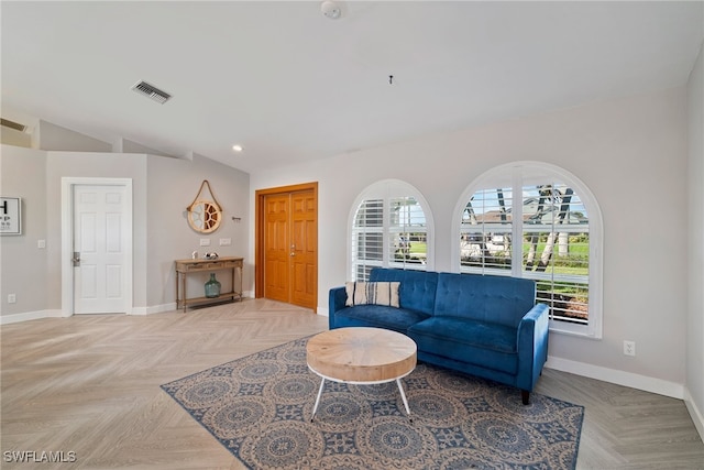 living room with light parquet floors and vaulted ceiling