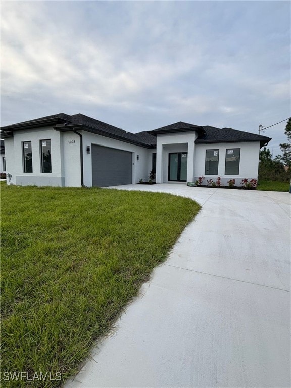 view of front of house with a front lawn and a garage