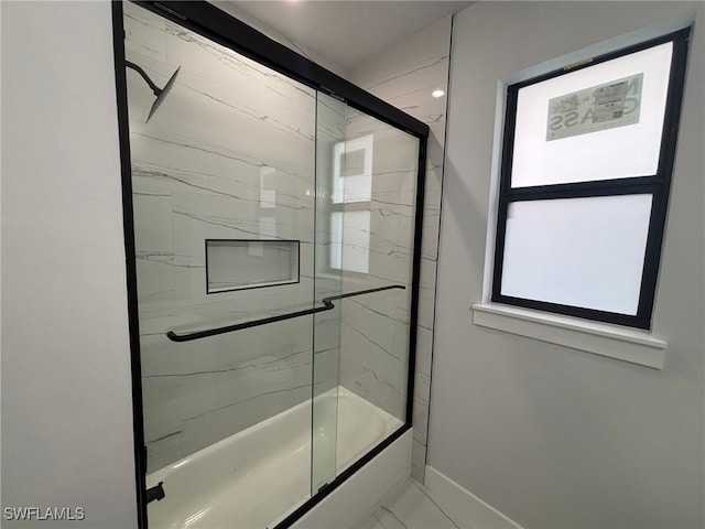 bathroom with shower / bath combination with glass door