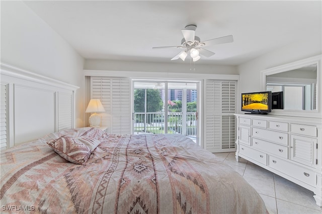 bedroom featuring access to outside, light tile patterned floors, and ceiling fan