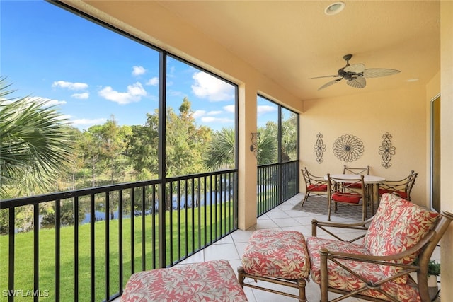 sunroom featuring ceiling fan