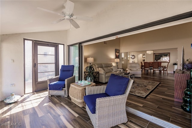 living room with dark hardwood / wood-style flooring, ceiling fan, and lofted ceiling