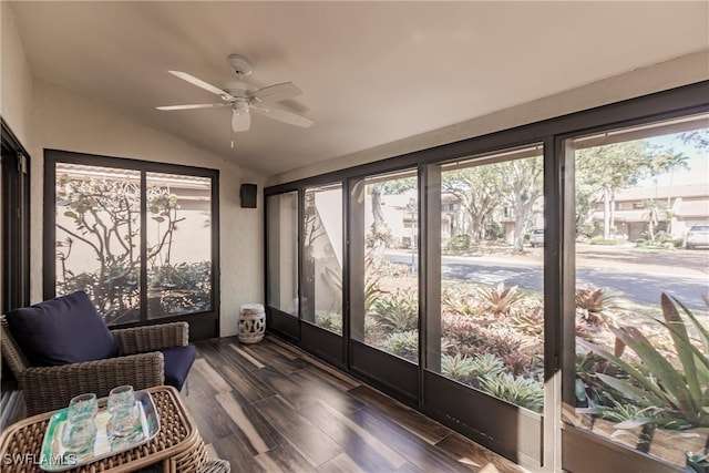 sunroom with ceiling fan, a healthy amount of sunlight, and vaulted ceiling