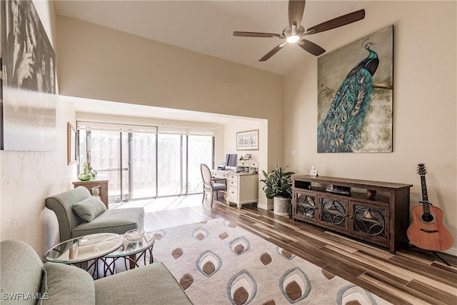 living room with hardwood / wood-style flooring, ceiling fan, and lofted ceiling