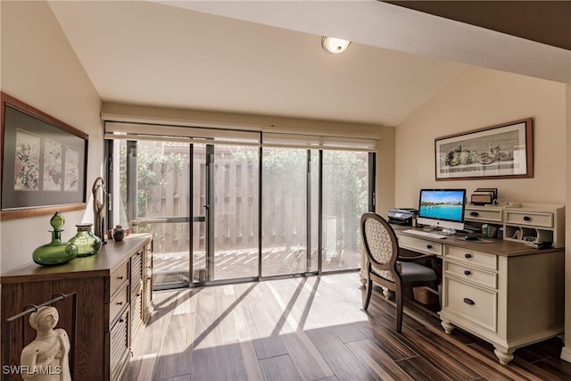 office space featuring a healthy amount of sunlight, lofted ceiling, and dark wood-type flooring