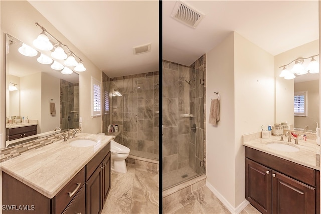 bathroom featuring vanity, toilet, and walk in shower