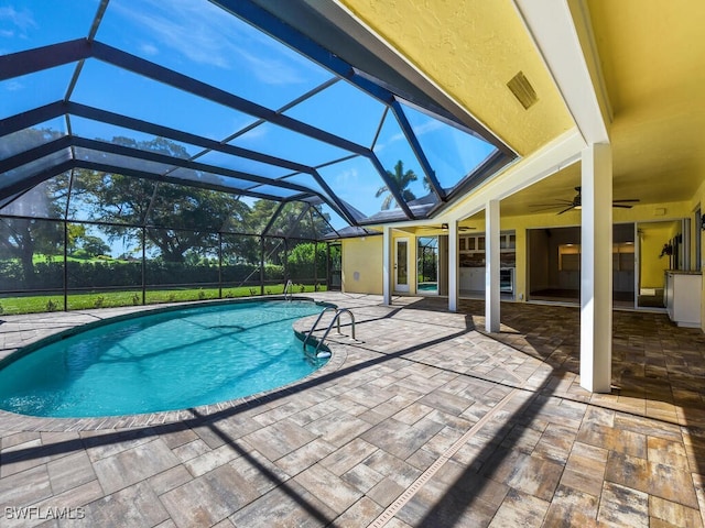 view of pool with a lanai, a patio, and ceiling fan