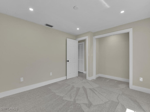 unfurnished bedroom featuring light carpet