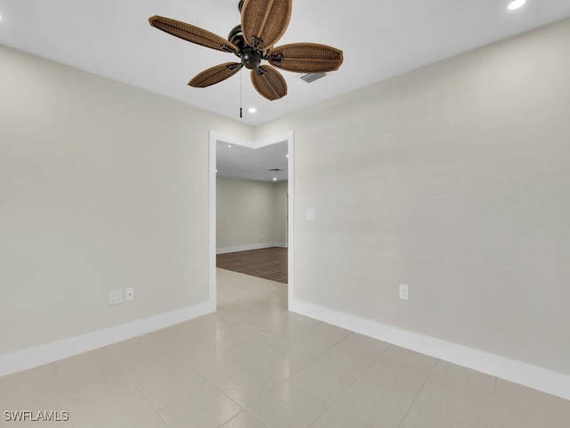 spare room with light tile patterned flooring and ceiling fan