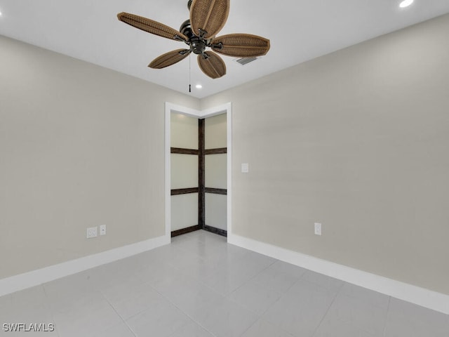 empty room featuring ceiling fan and light tile patterned floors