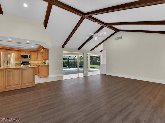 unfurnished living room featuring high vaulted ceiling, ceiling fan, beamed ceiling, and dark hardwood / wood-style flooring