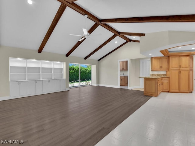 unfurnished living room with light hardwood / wood-style flooring, beam ceiling, ceiling fan, and high vaulted ceiling