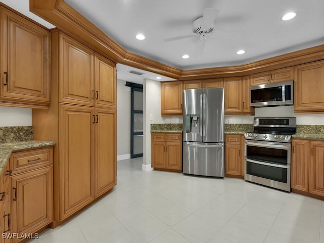 kitchen featuring light stone countertops, stainless steel appliances, and ceiling fan