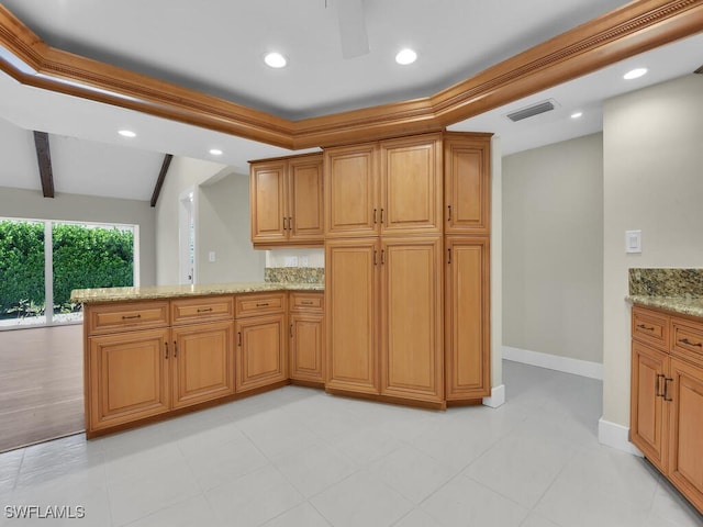 kitchen with light stone counters, beam ceiling, and kitchen peninsula