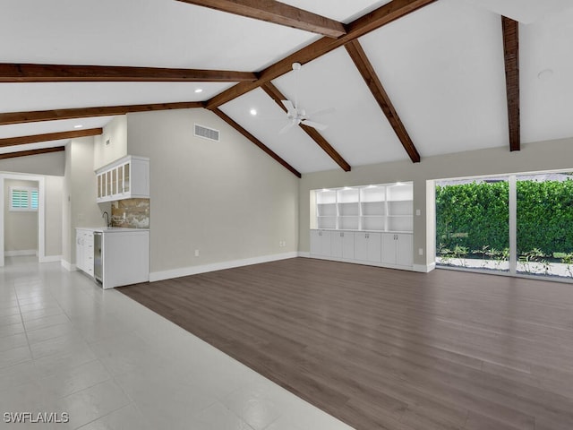 unfurnished living room with beam ceiling, beverage cooler, ceiling fan, and hardwood / wood-style flooring