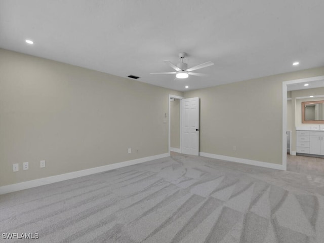 unfurnished room with ceiling fan and light carpet