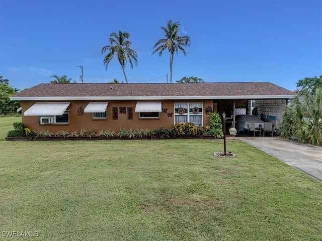 ranch-style home with a carport and a front yard