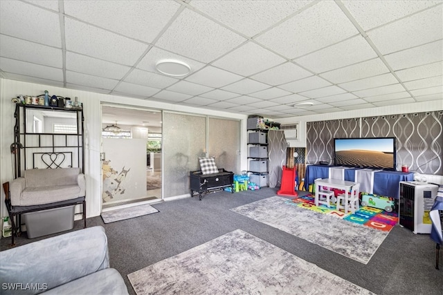 playroom with a drop ceiling and carpet floors