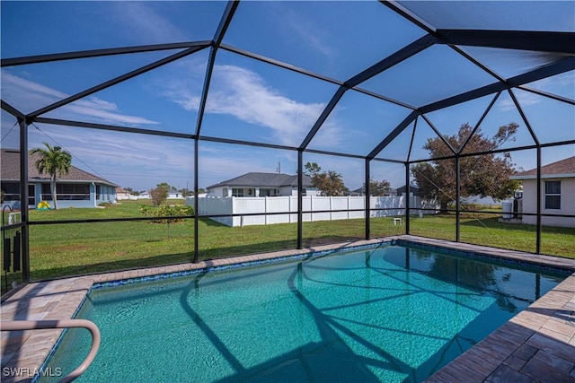 view of pool with a yard and a lanai