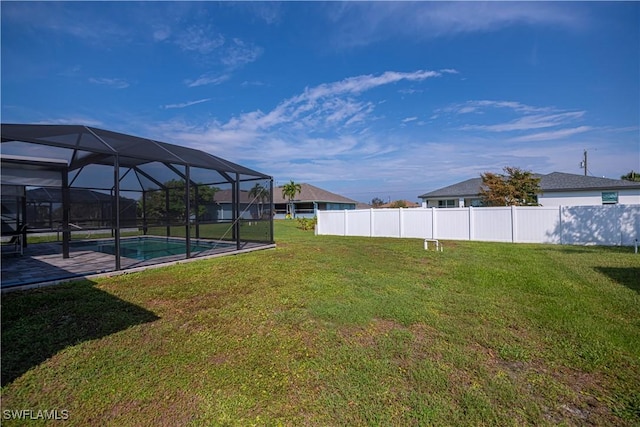 view of yard with glass enclosure and a fenced in pool