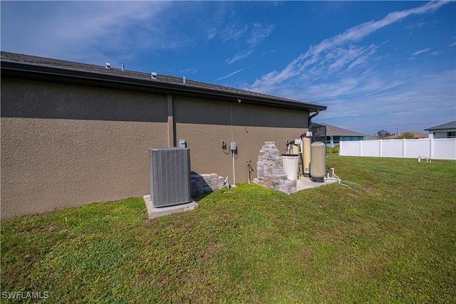 rear view of property with a yard and cooling unit