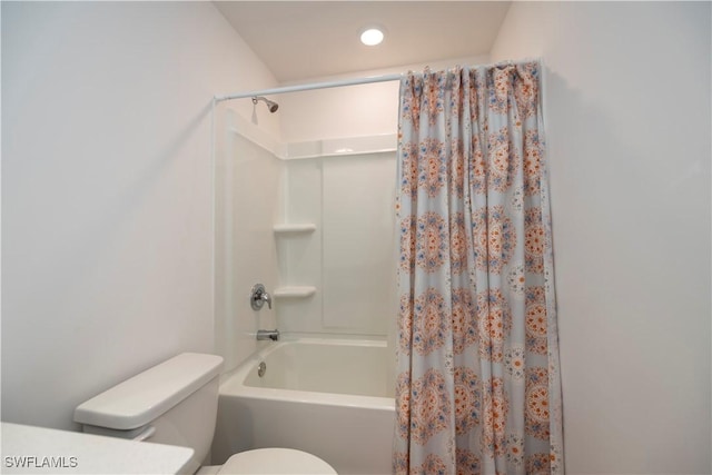 bathroom with shower / bath combo and toilet