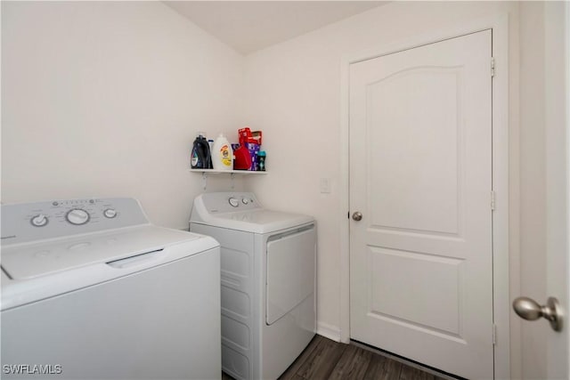 clothes washing area with washer and dryer and dark hardwood / wood-style flooring