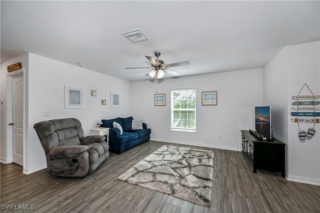 living room featuring ceiling fan and dark hardwood / wood-style flooring