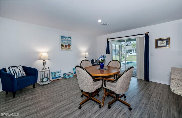 dining room with dark hardwood / wood-style floors